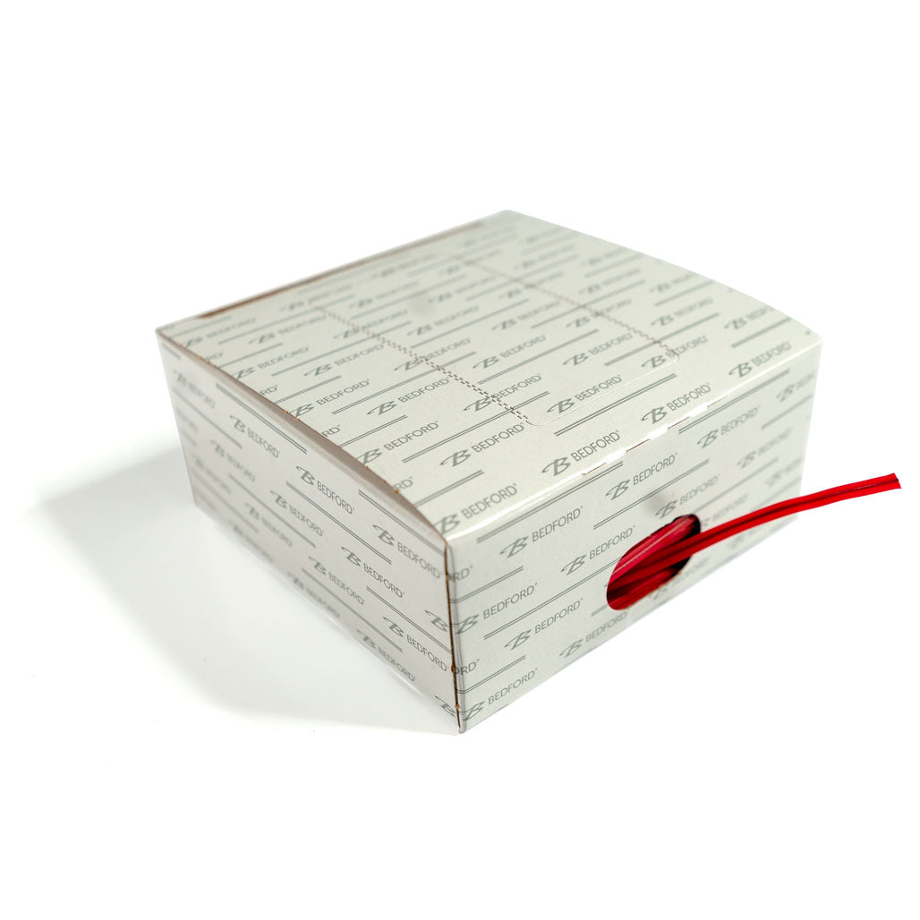 4 inch red plastic twist tie dispensing out of side of twist tie case